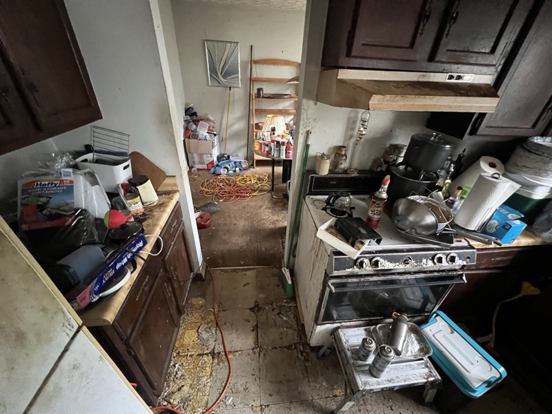 Cluttered, outdated kitchen in a Stone Mountain, GA house before Mighty Estates bought it as-is